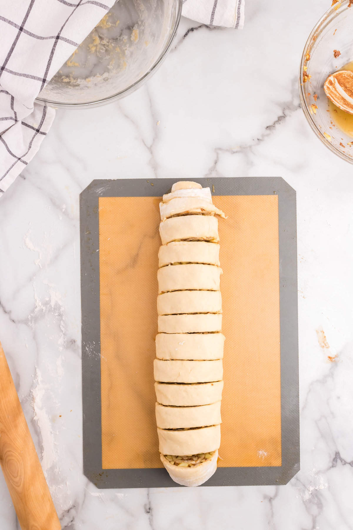Slicing rolled dough and apple mixture for Apple Cinnamon Rolls