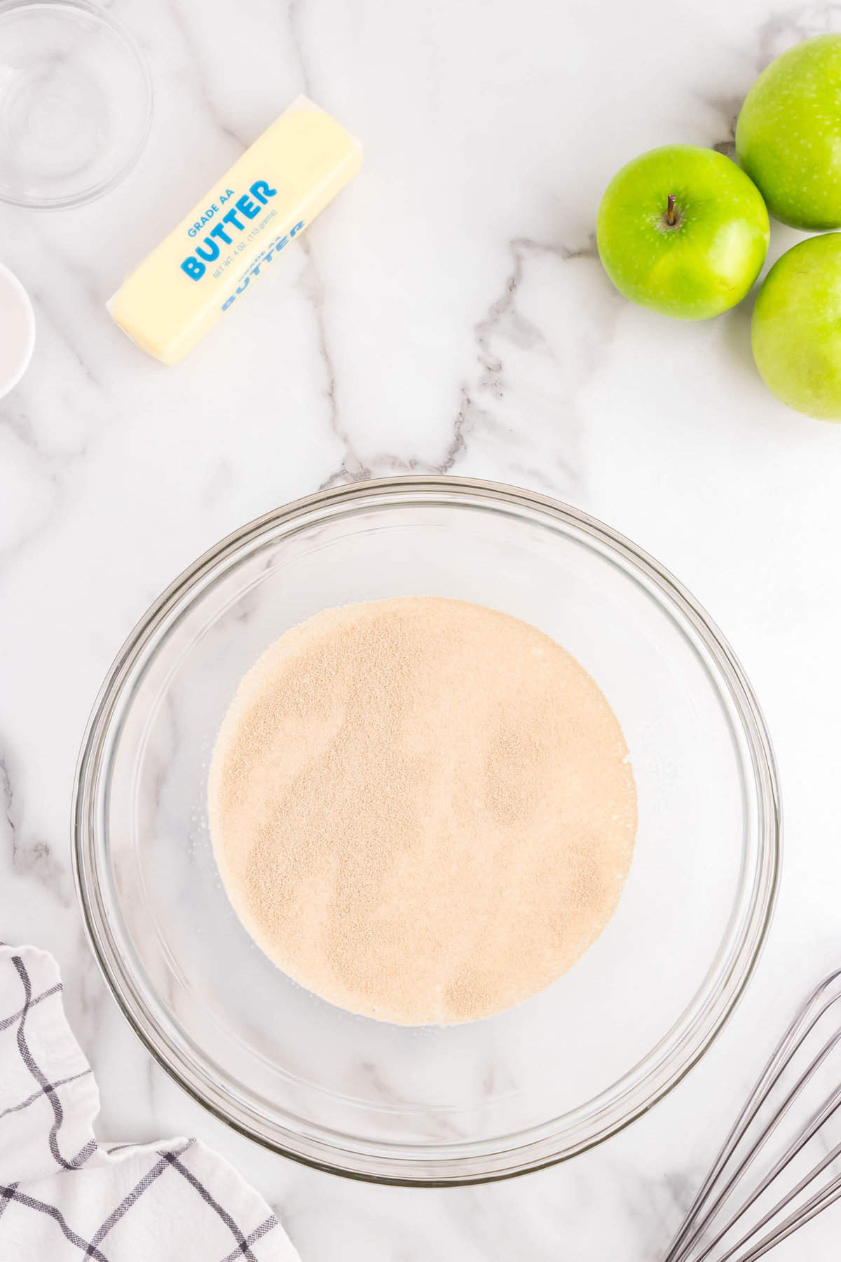 Tossing sugars in mixing bowl for Apple Cinnamon Rolls recipe