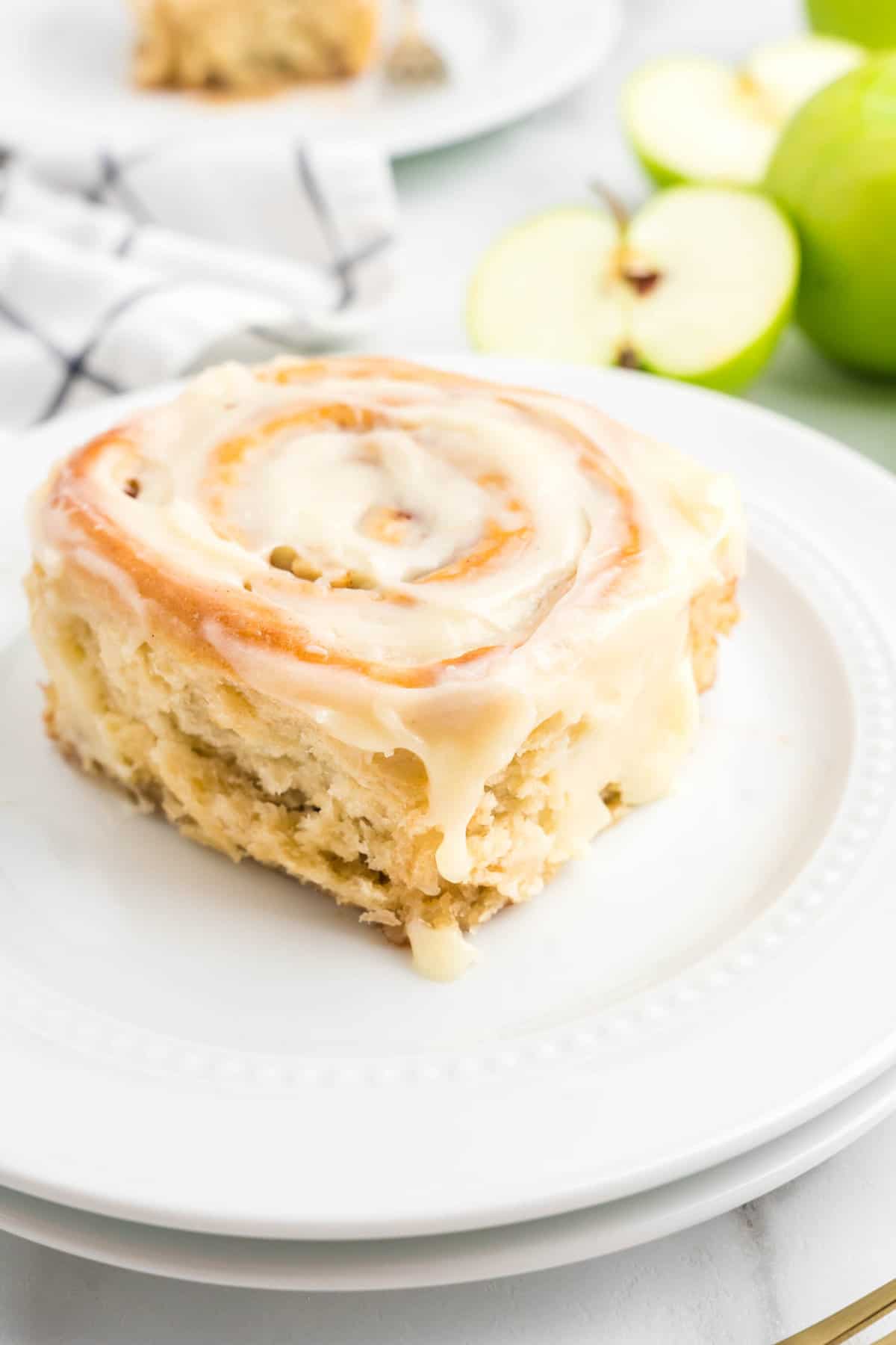 Frosted Apple Cinnamon Roll on plate close up
