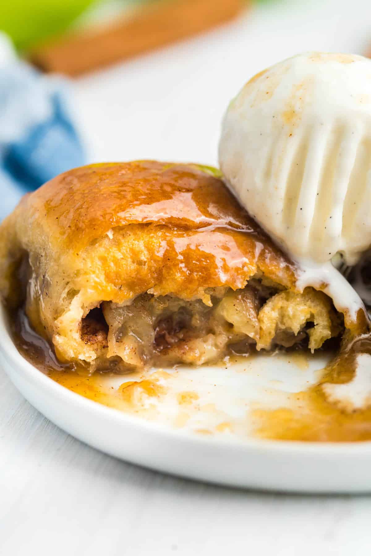 Crescent Roll Apple Dumplings topped with vanilla ice cream on plate