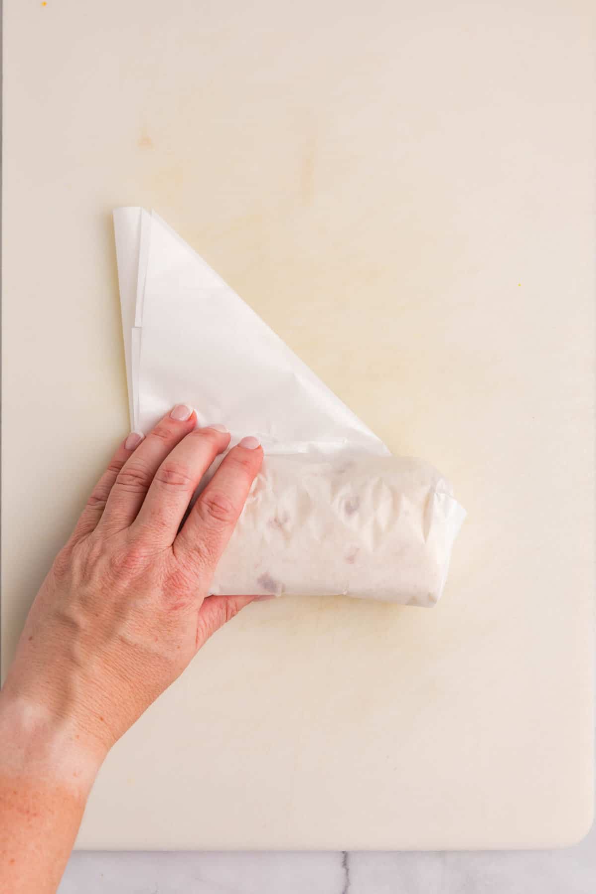 Wrapping breakfast burrito in parchment paper