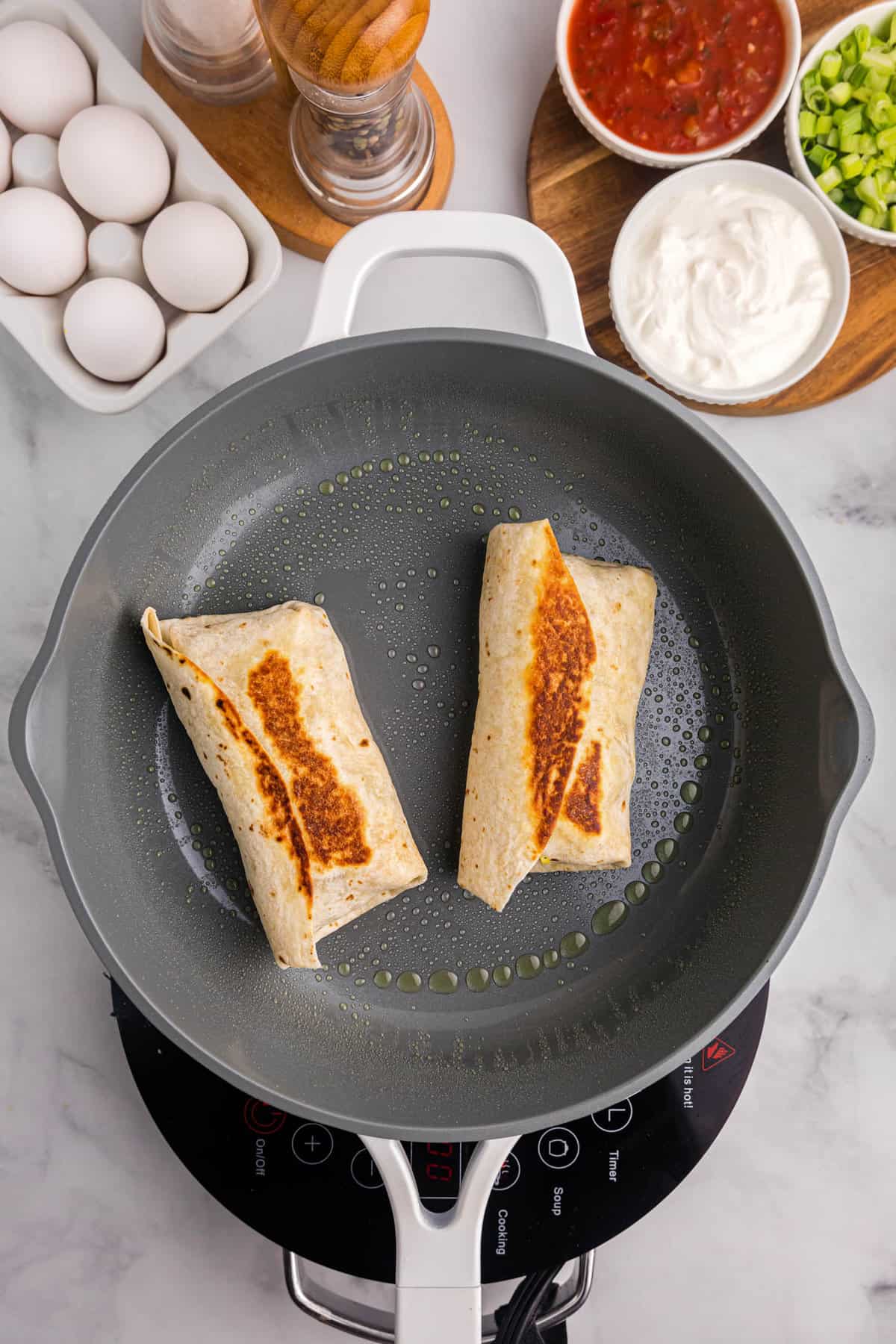 Toasted Breakfast Burritos in skillet