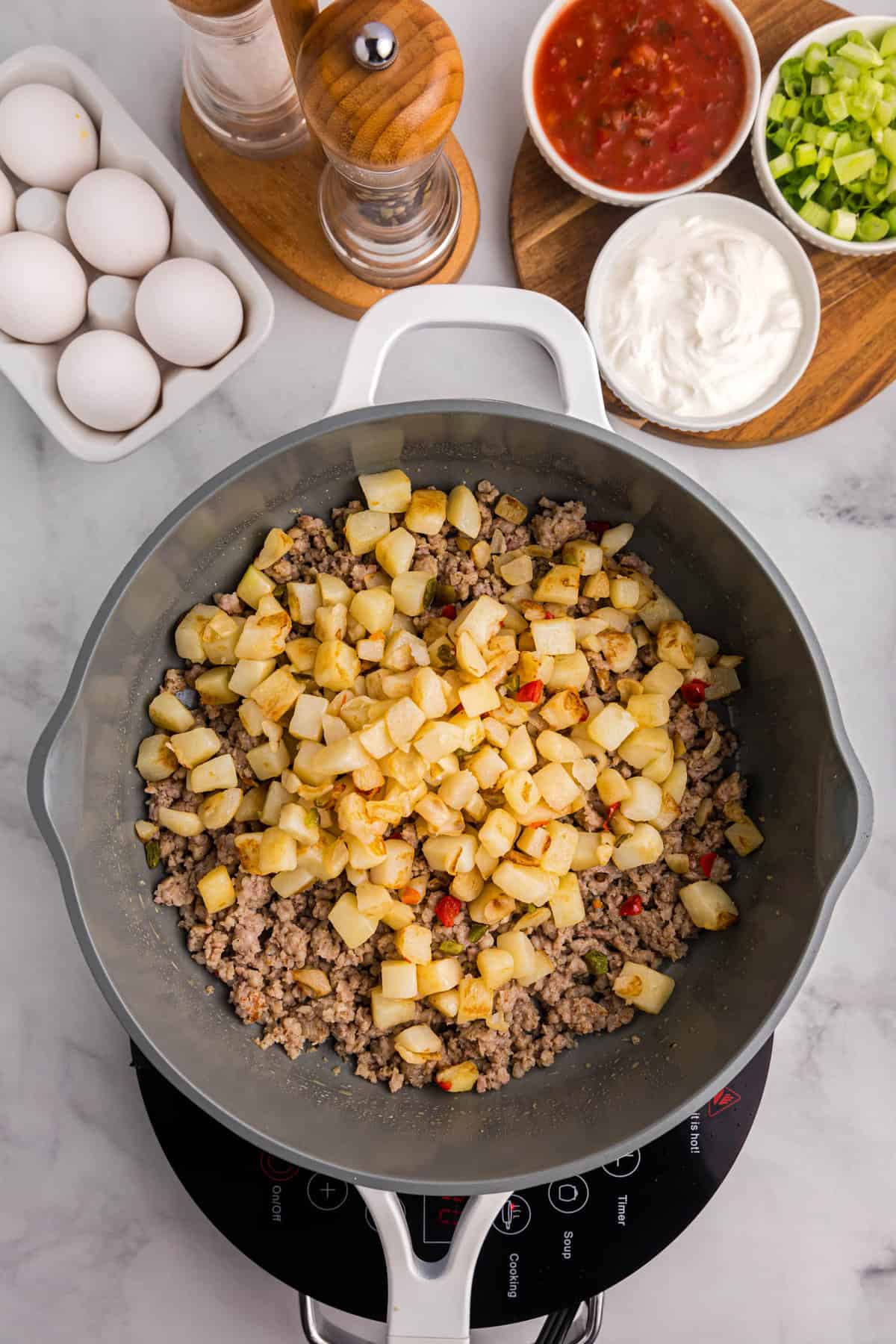 Skillet with ground sausage and potatoes cooked