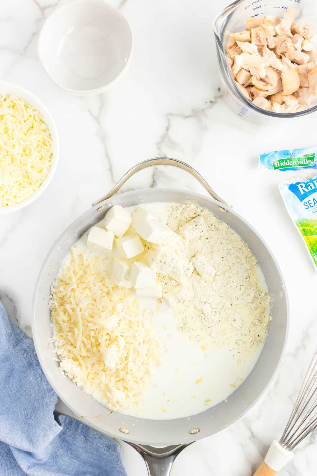 Blending sauce ingredients for Chicken Bacon Ranch Casserole in pan