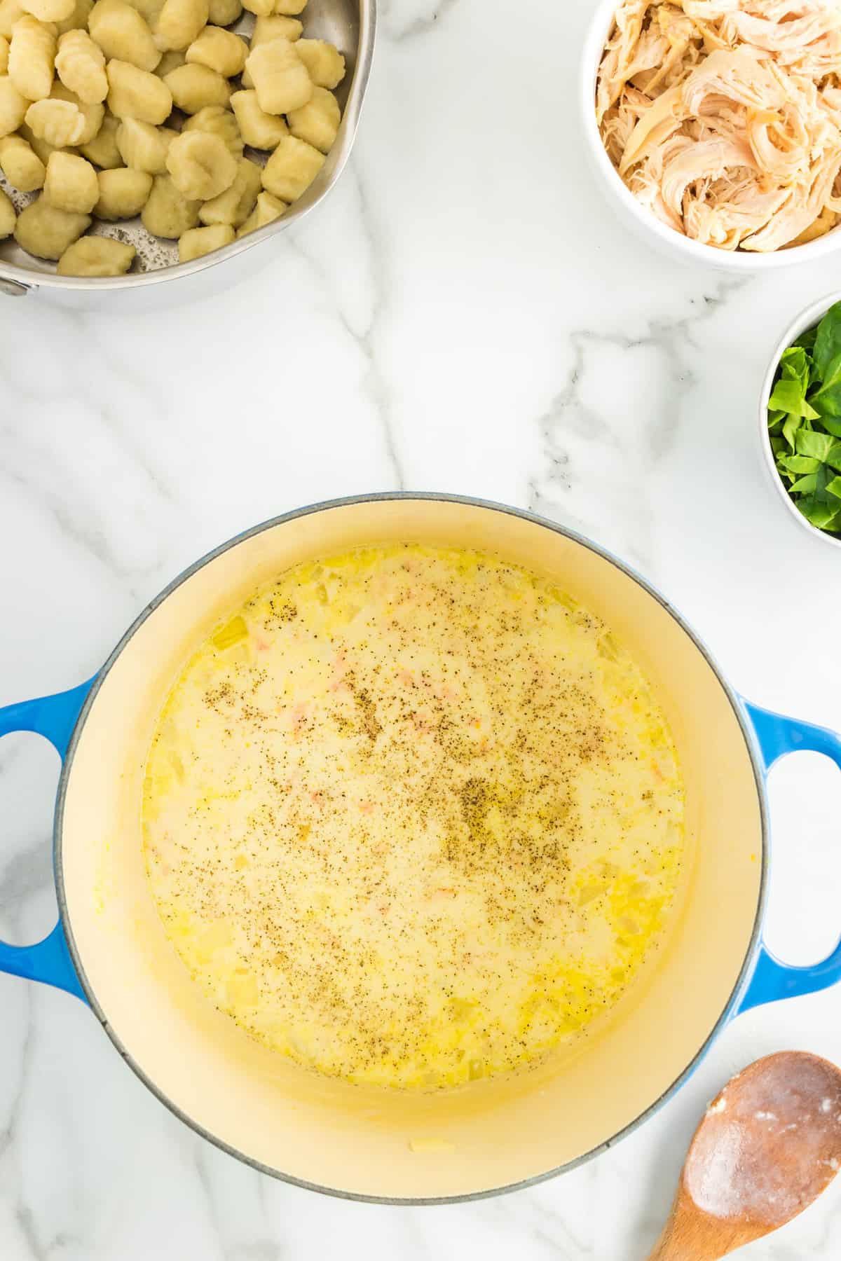 Adding Salt & Pepper to Season Chicken and Gnocchi Soup Recipe