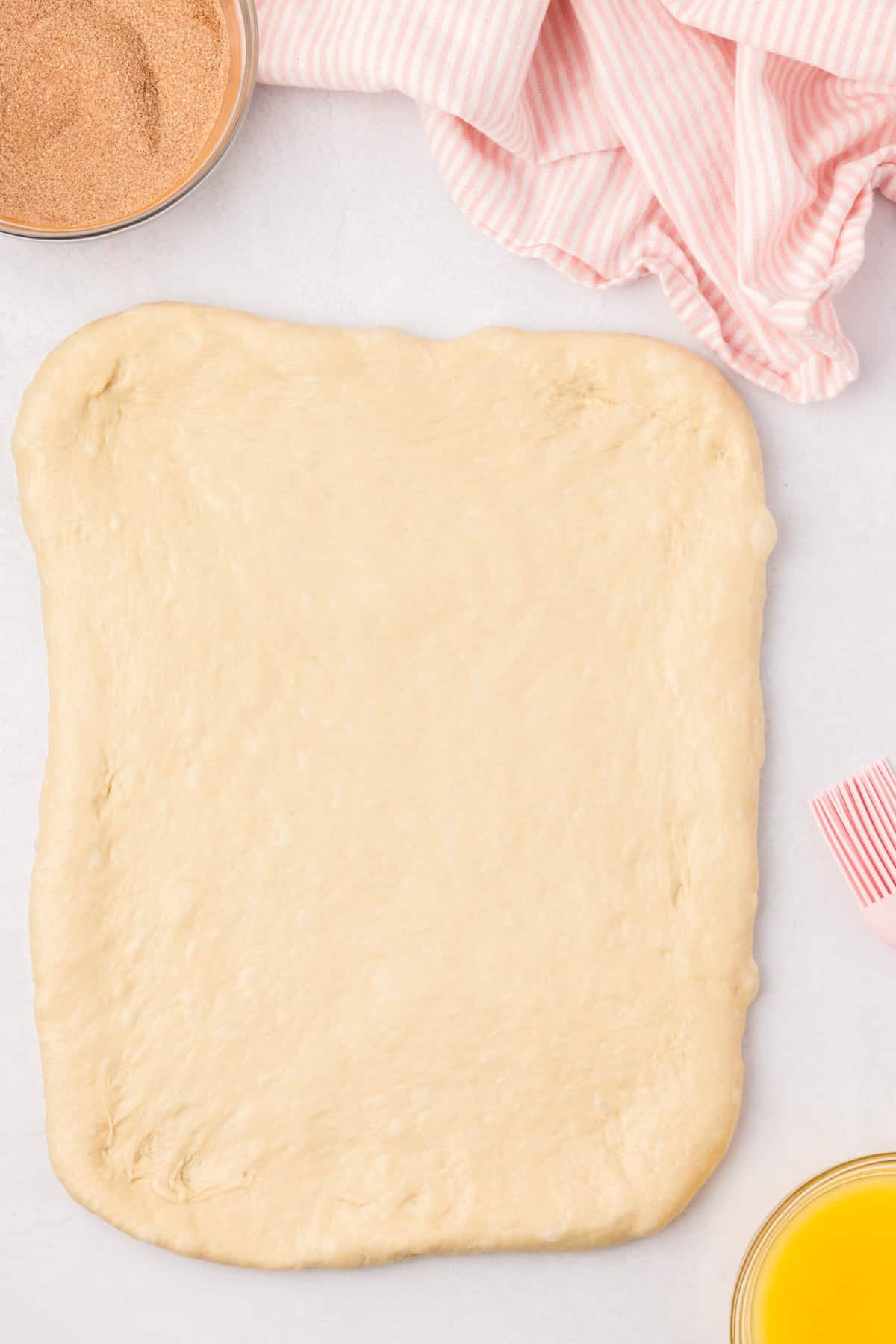 Rolled out dough ball to 9x13 size on counter for Cinnamon Swirl Bread