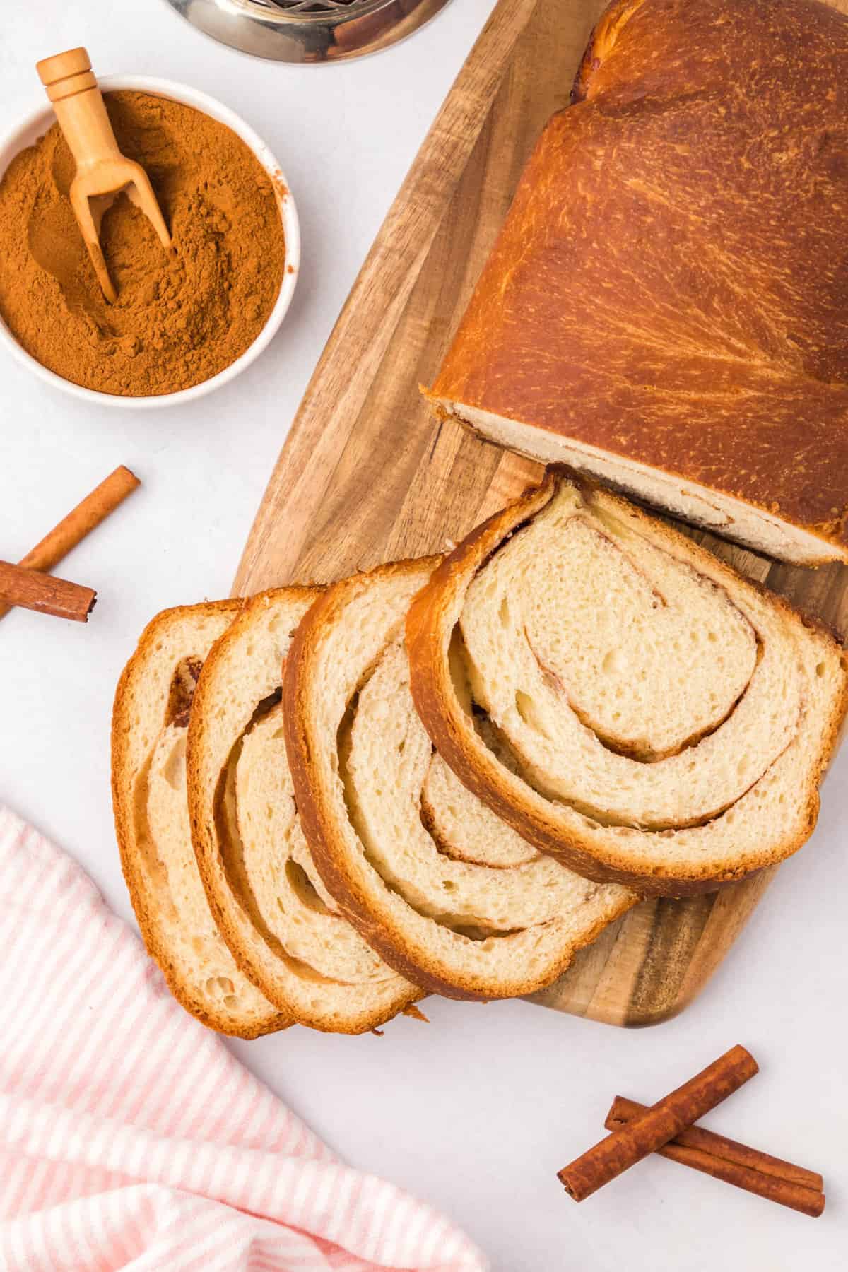 Cinnamon Swirl Bread Recipe sliced on wooden cutting board