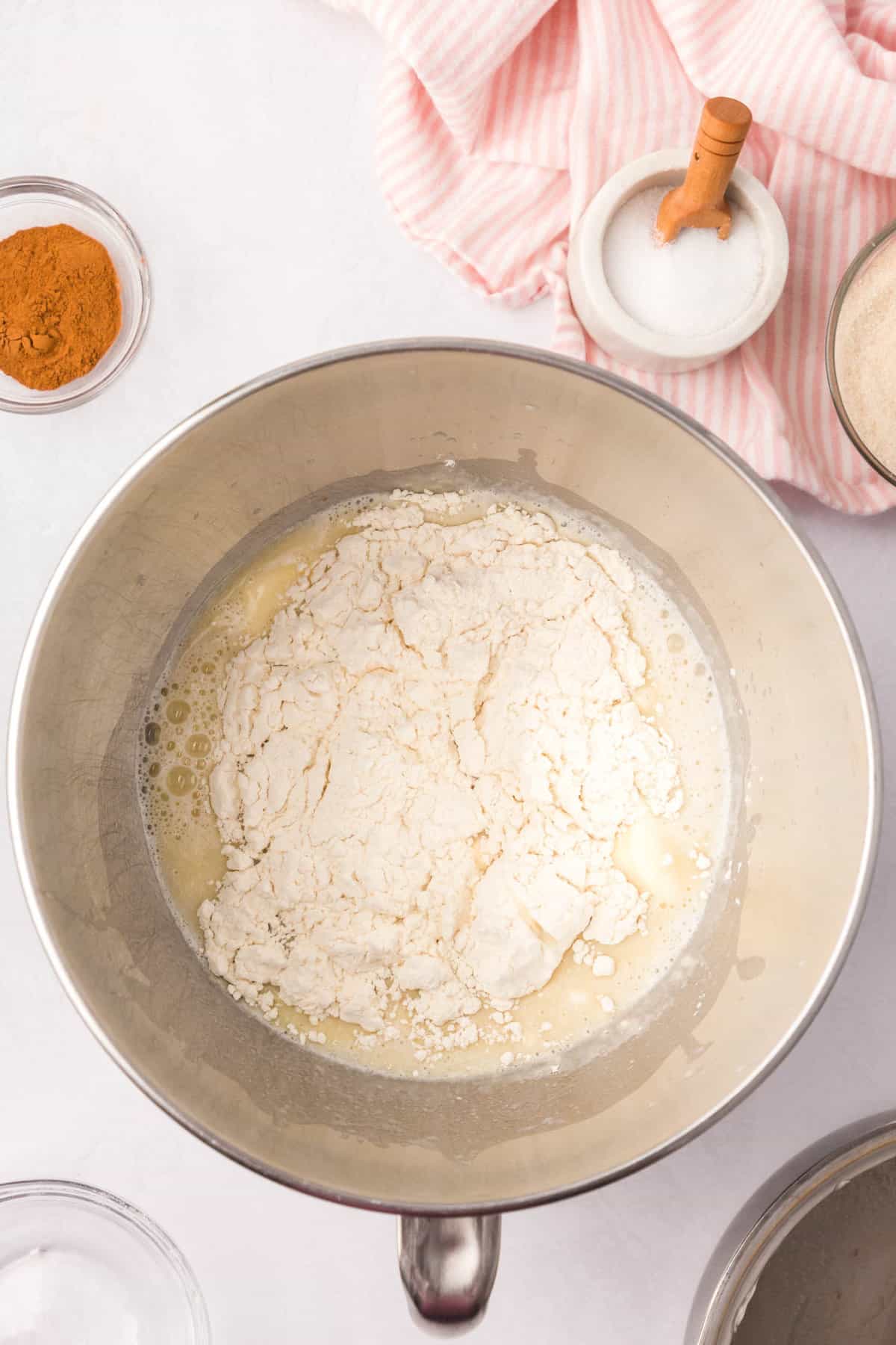 Adding flour to combined yeast mixture for Cinnamon Swirl Bread recipe