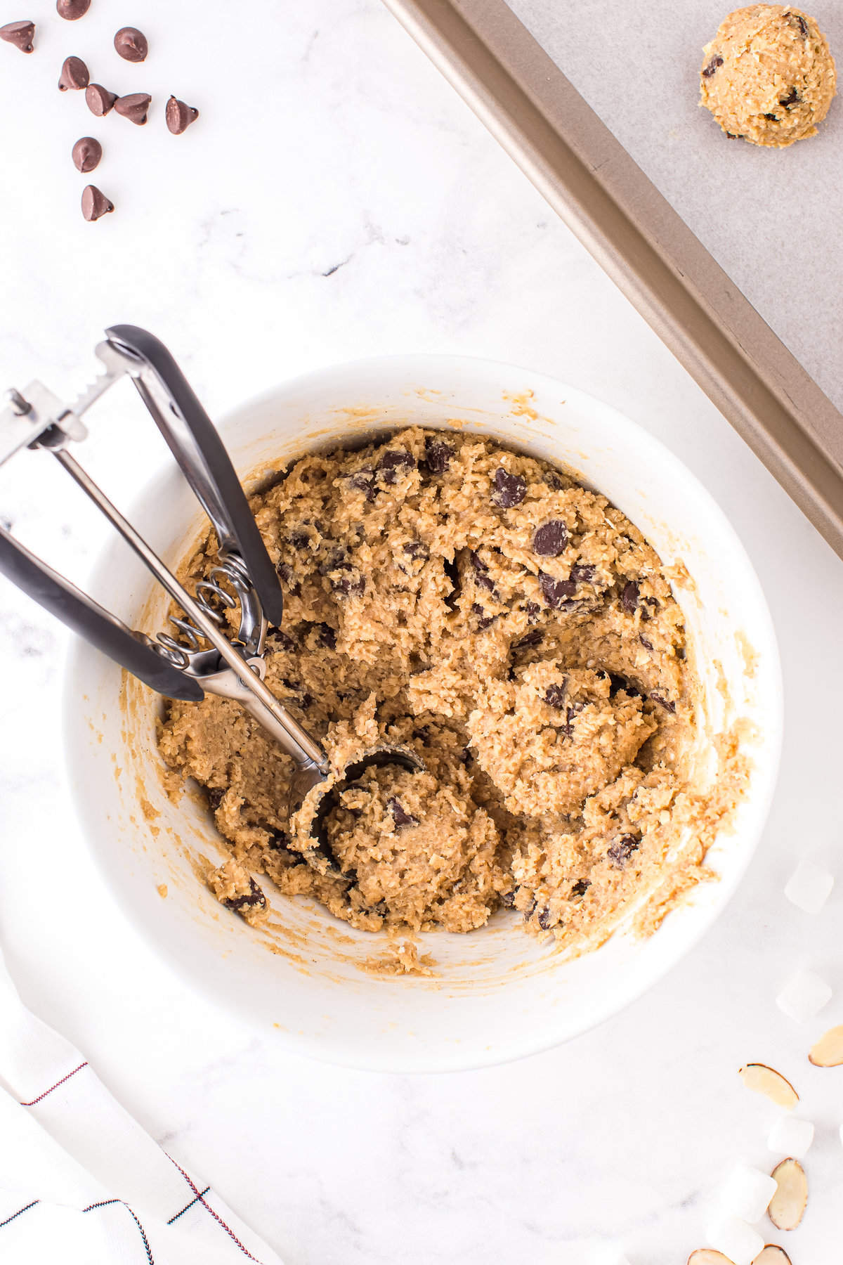Fold in chocolate chips and use a 2 inch cookie scoop to place batter onto a cookie sheet.
