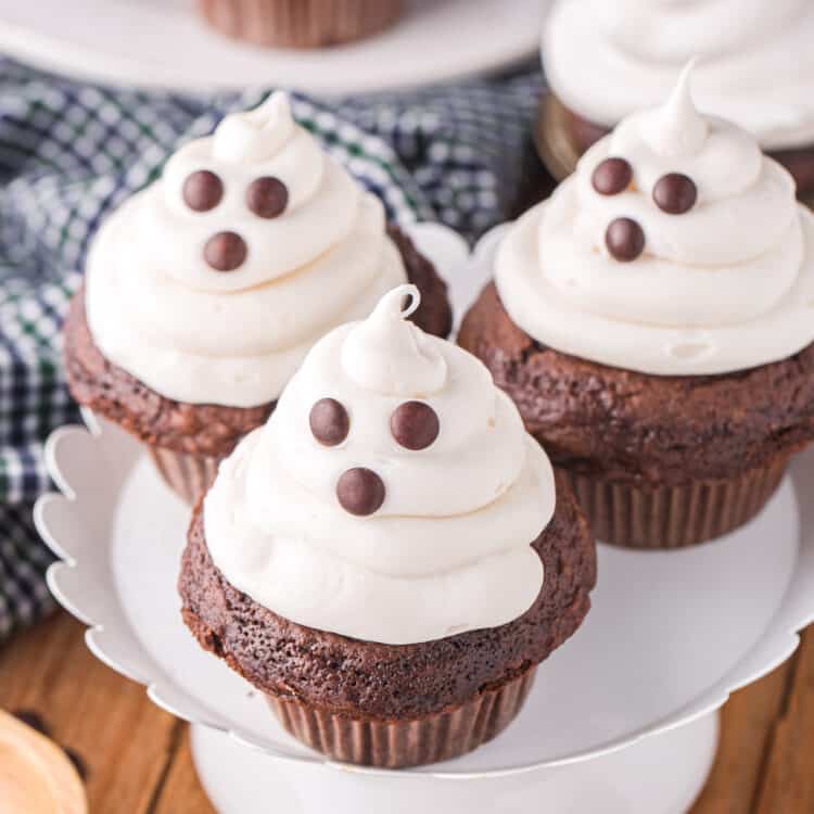 An overhead photo of completed cupcakes displayed on a white cupcake stand.