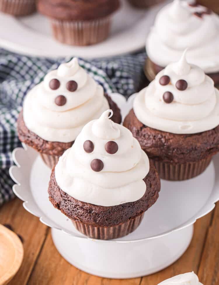 An overhead photo of completed cupcakes displayed on a white cupcake stand.