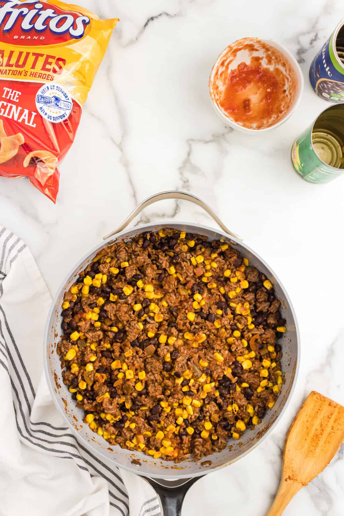 Combined ground beef, corn, salsa, and black beans in skillet for Frito Casserole recipe