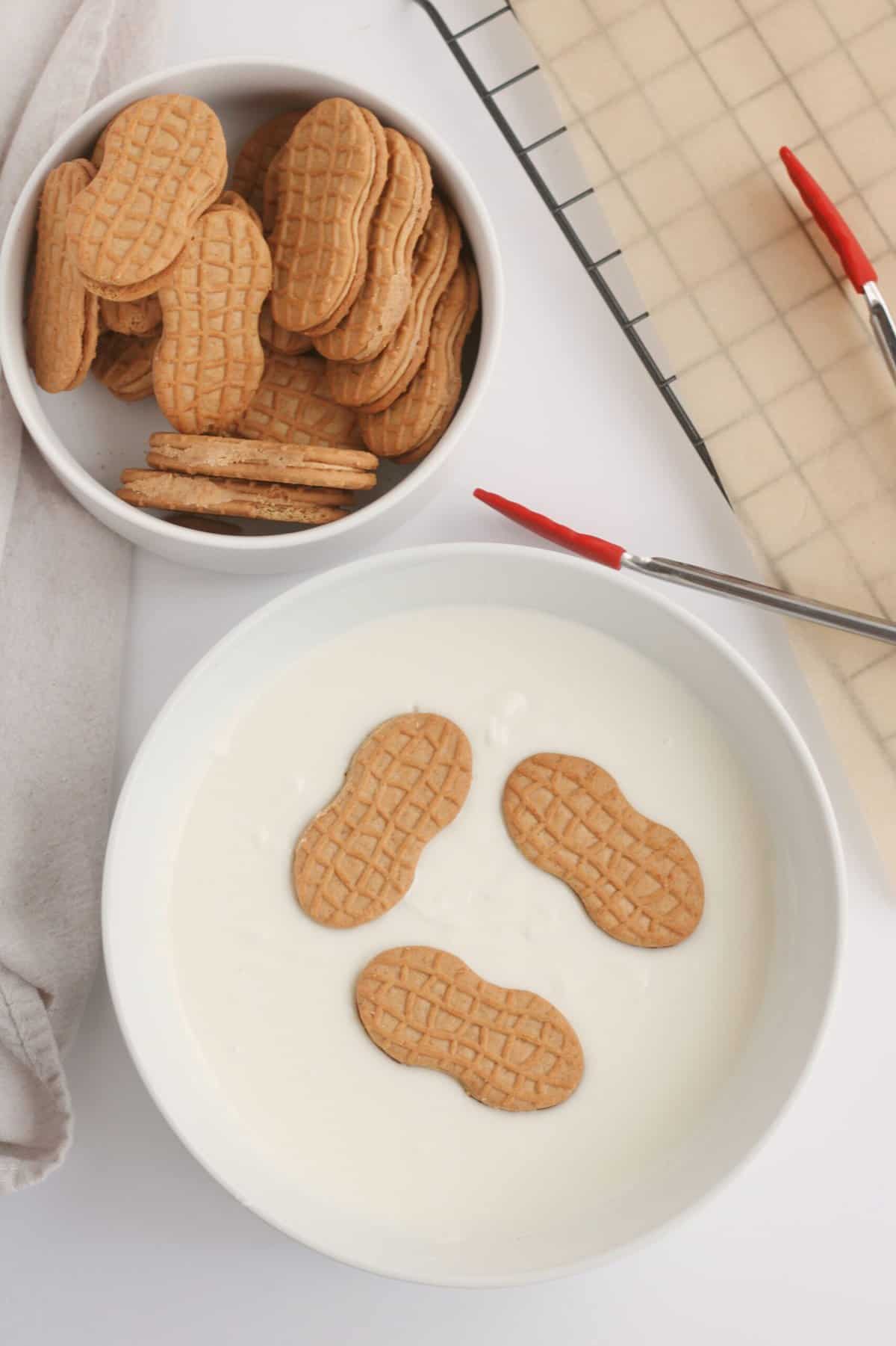 Dip the Nutter Butter Cookies in to the melted Almond Bark.