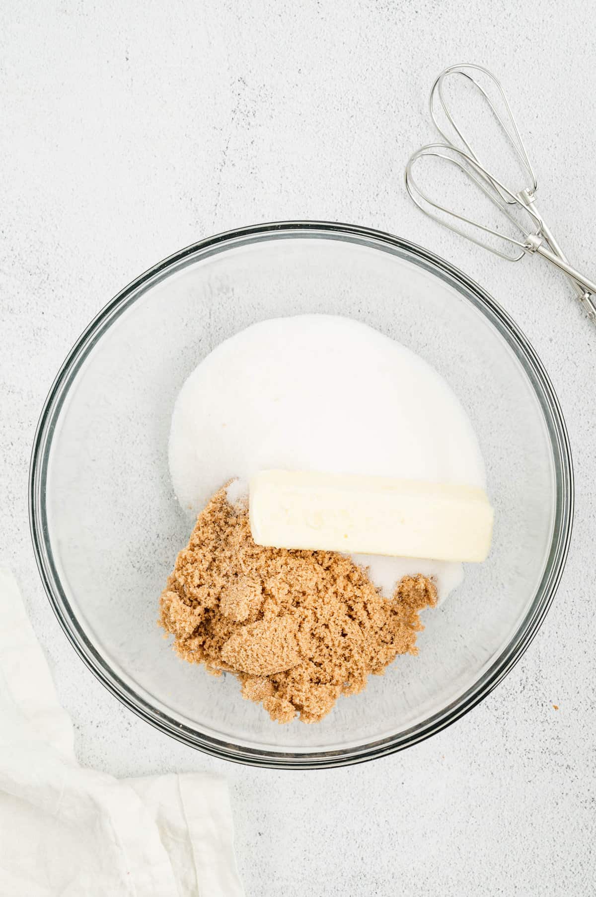 Butter and sugars in mixing bowl for Monster Cookie Bars recipe