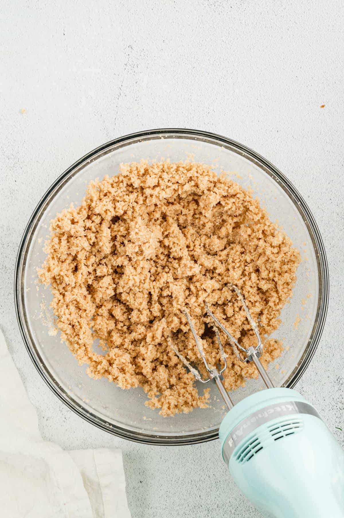 Mixing ingredients in bowl for Monster Cookie Bars base