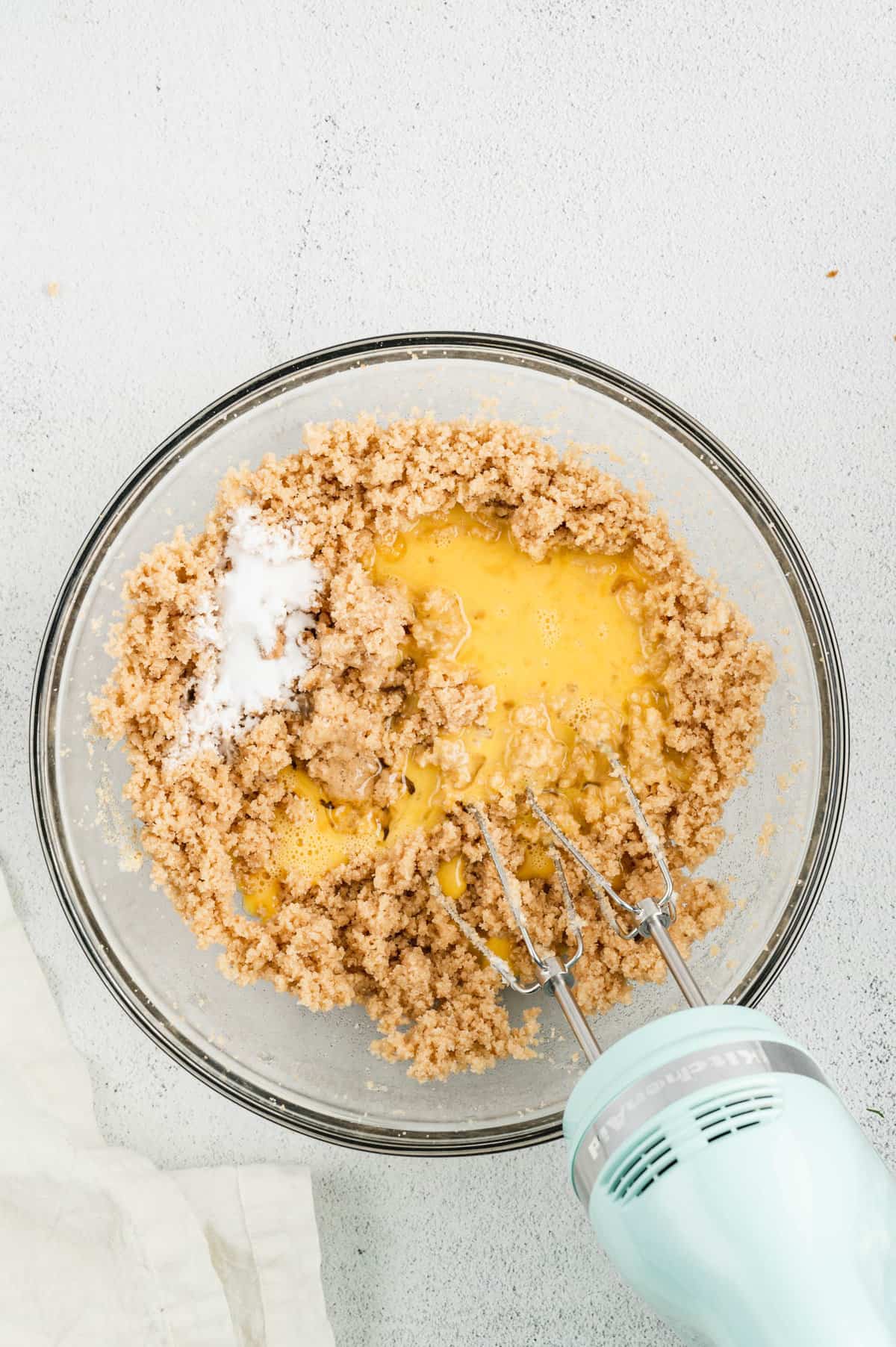 Adding ingredients Monster Cookie Bars in mixing bowl