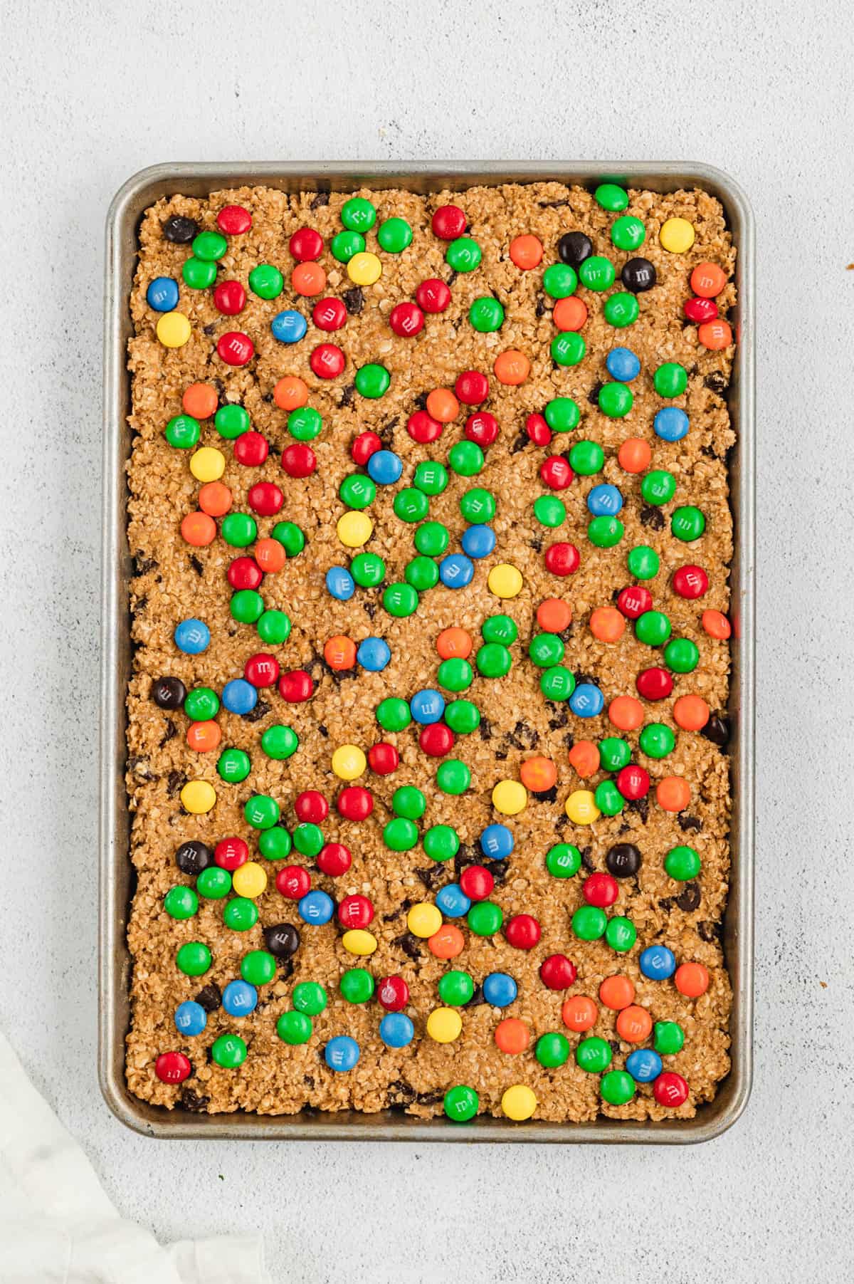 Monster Cookie Bars Topped with M&Ms in baking pan