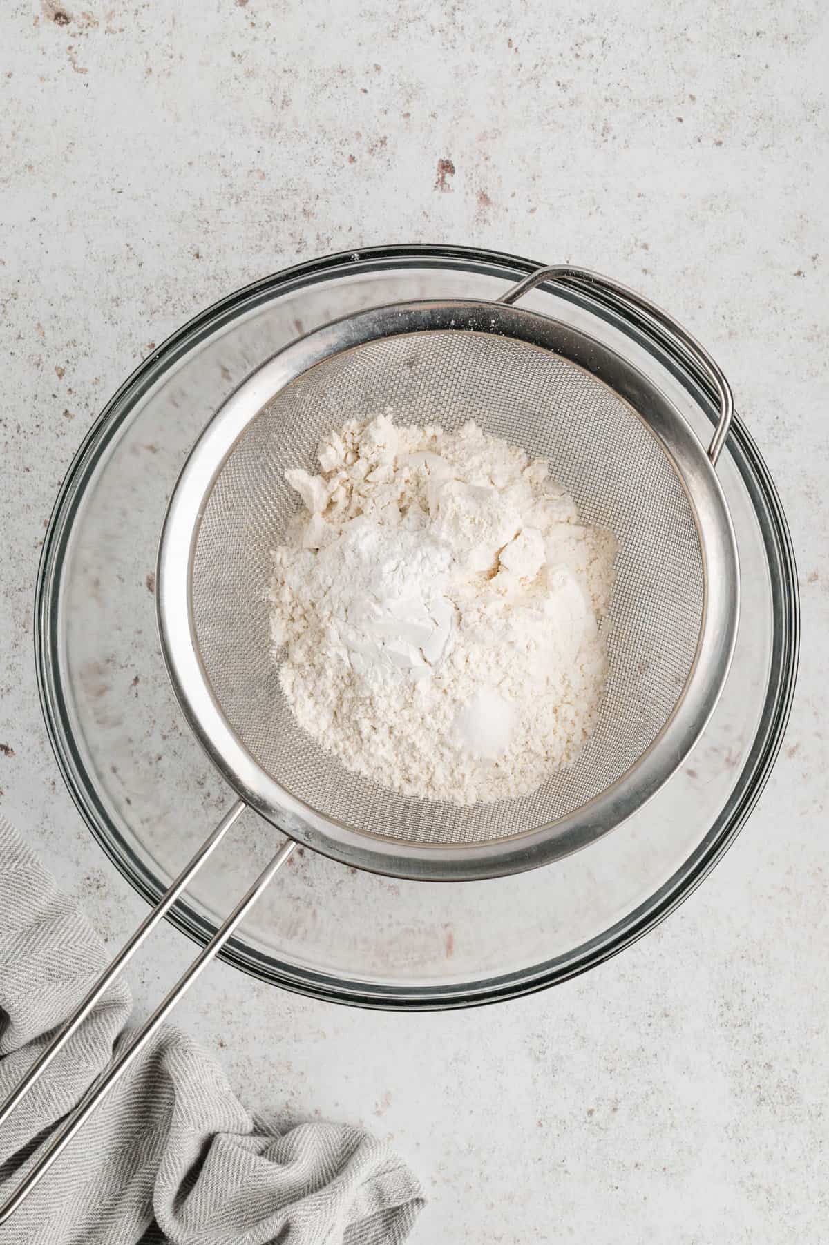 Sifting dry ingredients in mixing bowl for Pancake Recipe