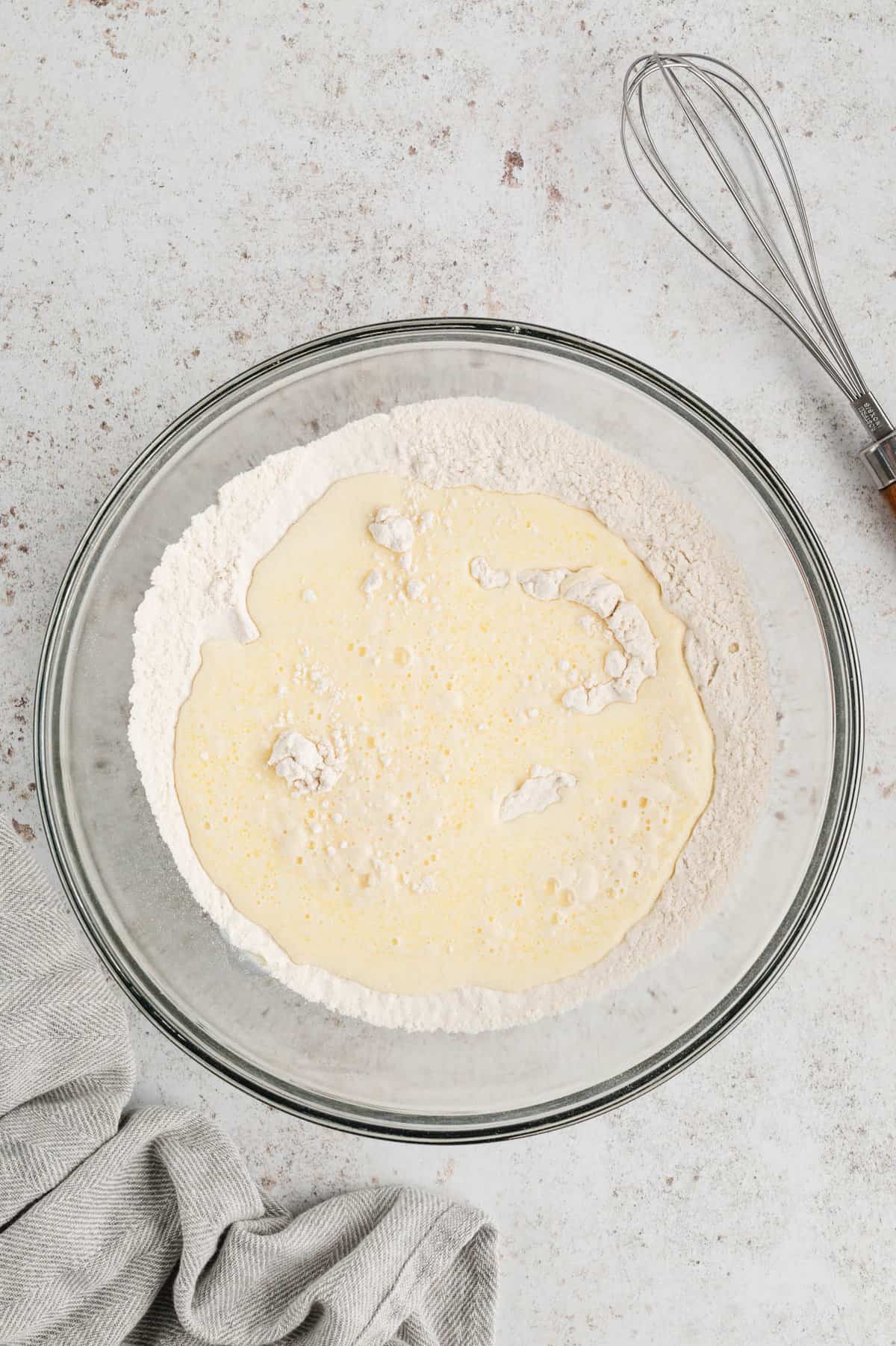 Combining wet and dry ingredients in mixing bowl for Sifting dry ingredients in mixing bowl for Pancake Recipe