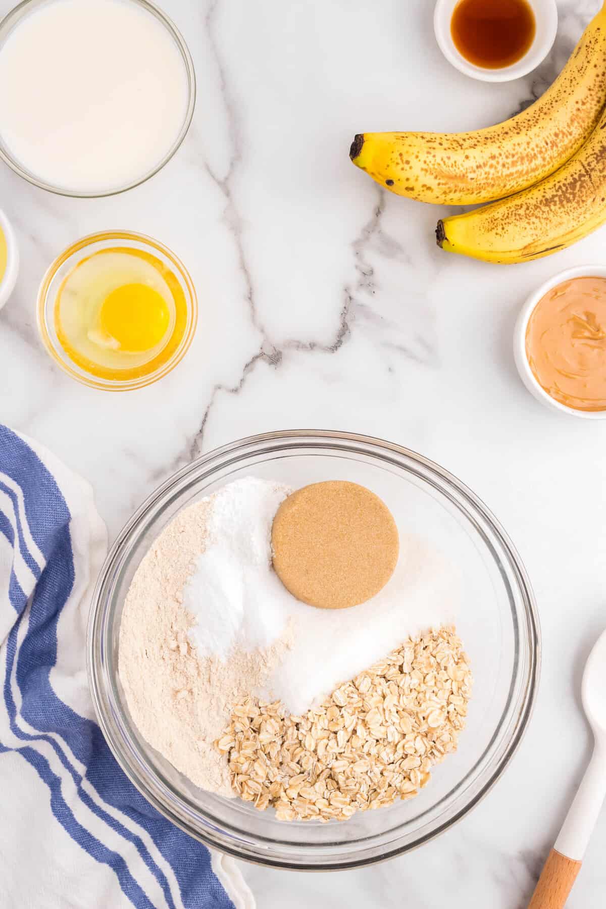 In a Medium Bowl add in all of the dry ingredients and shirt together. (Flour, Oats, White Sugar, Brown Sugar, Baking Powder, Baking Soda and Salt)