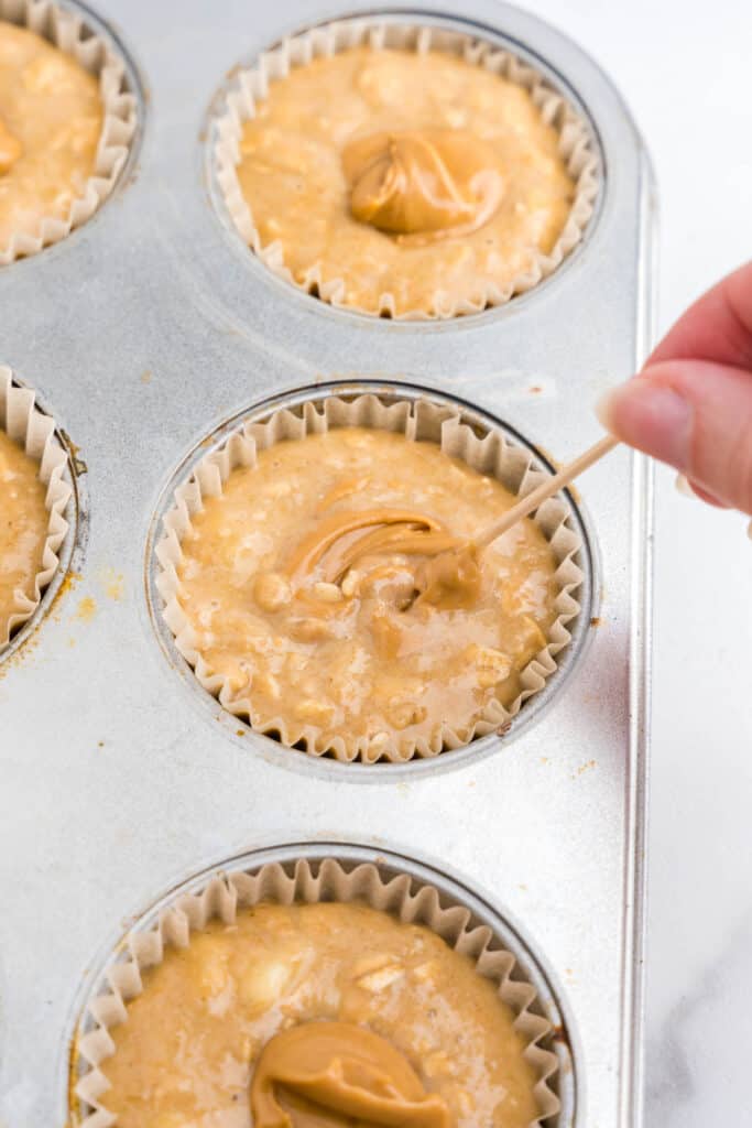 Divide batter evenly between 12 muffin cups. add in a teaspoon of peanut butter and mix together with a toothpick.