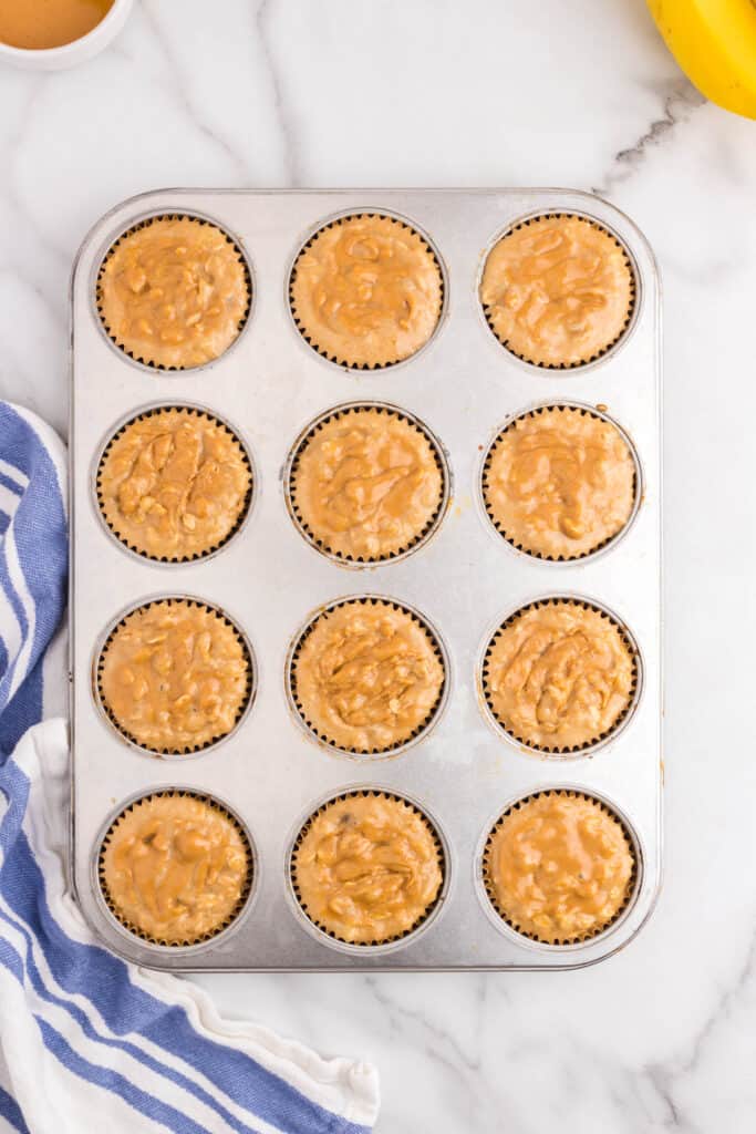 Muffin tin ready to be put in the oven .