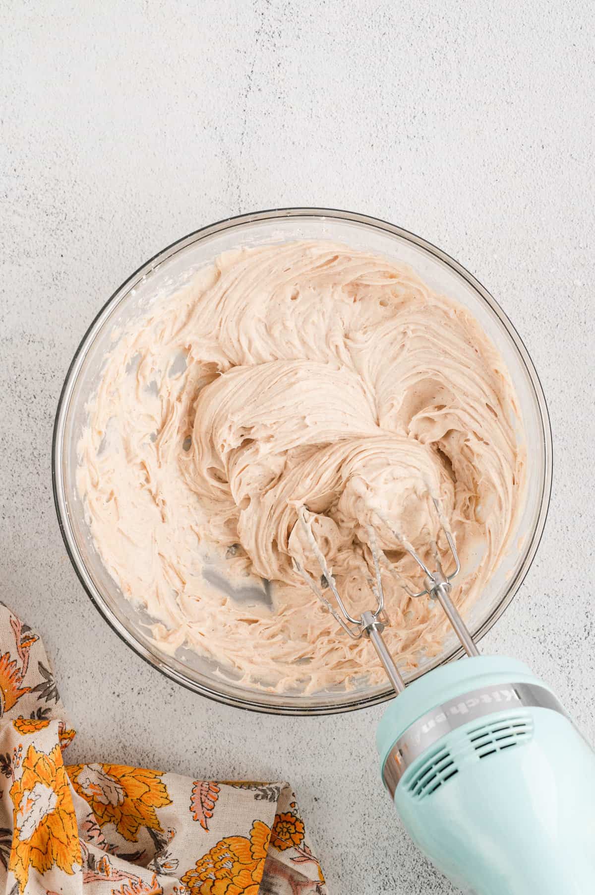Perfectly blended cream cheese frosting in mixing bowl for Pumpkin Bars recipe