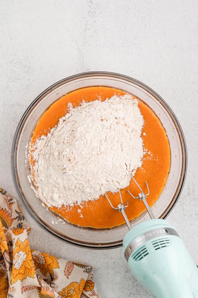 Adding Flour to Pumpkin Mixture in Mxing Bowl for Pumpkin Bars Recipe