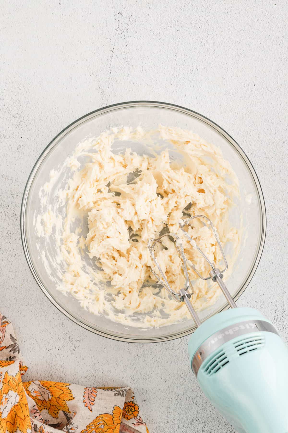 Mixed cream cheese frosting in mixing bowl for Pumpkin Bars