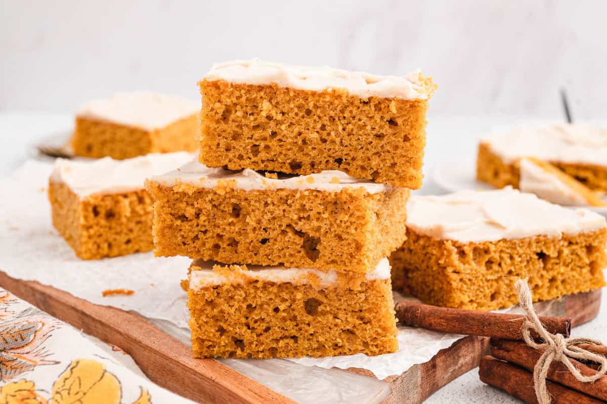 Pumpkin Bars with Cream Cheese Frosting Cut and Stacked on Serving Tray