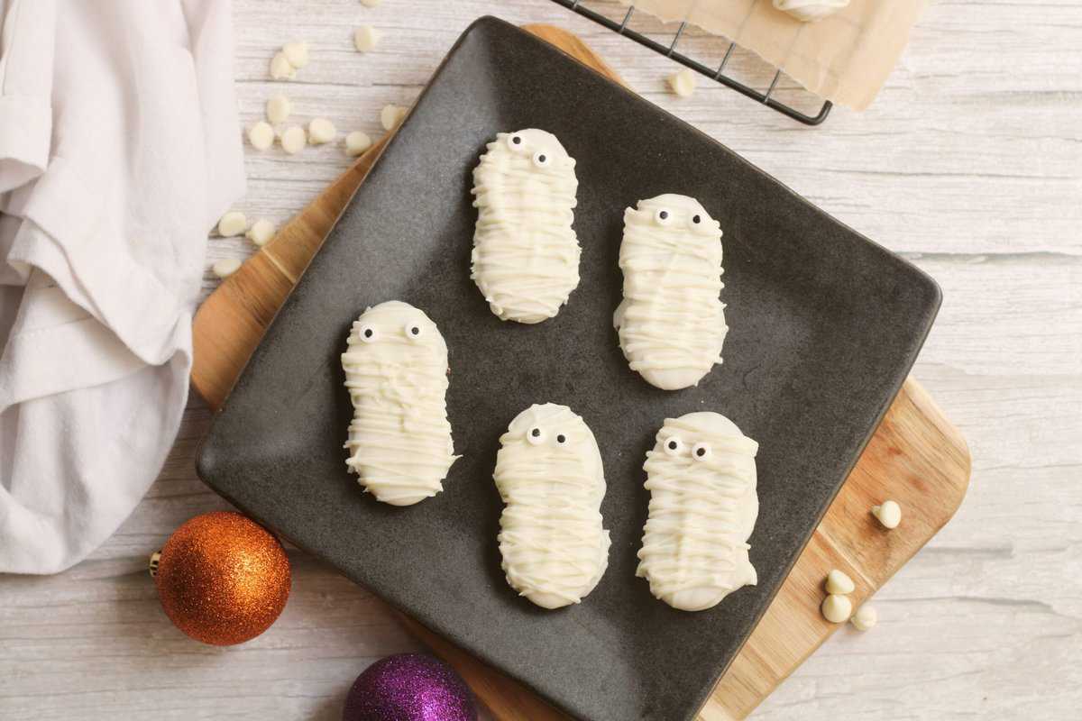 Mummy Cookies displayed on a black plate