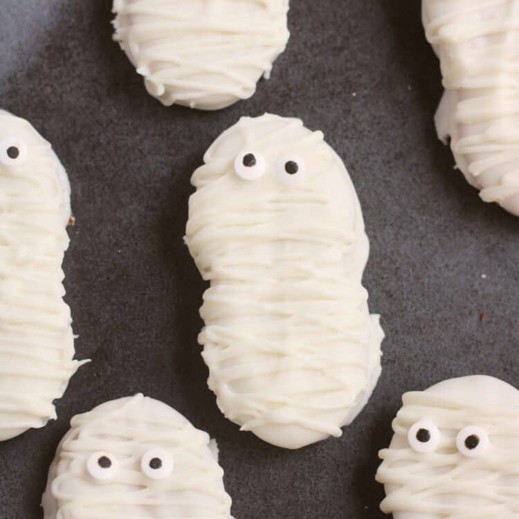 Close up photos of Nutter butter mummy cookies.