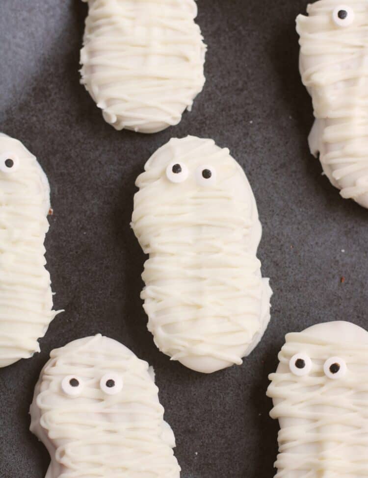 Close up photos of Nutter butter mummy cookies.