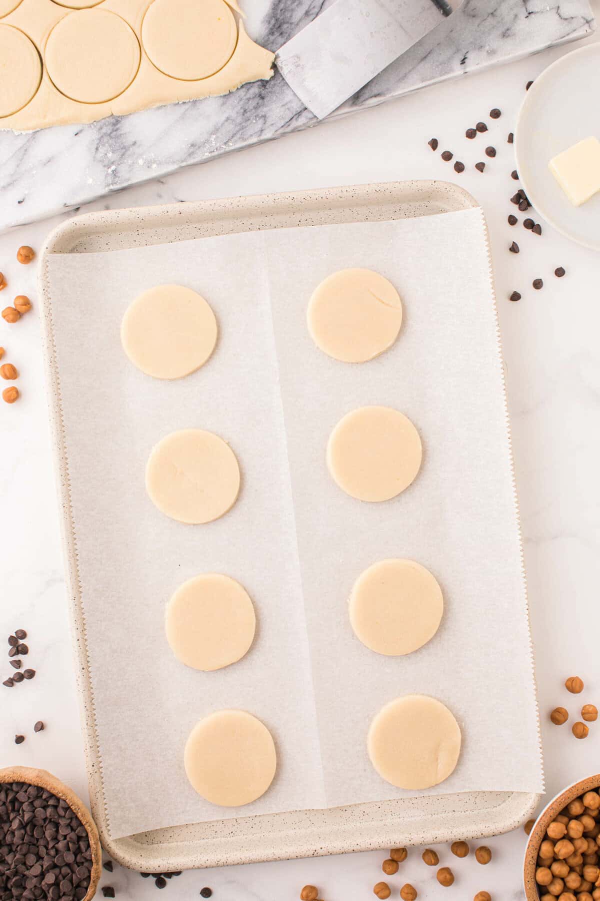 Cut Cookie Circles on Parchment-Lined Cookie Sheet for Twix Cookies