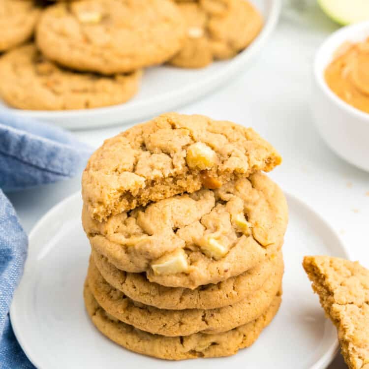 Apple and Peanut Butter Cookies stacked on plate with one cookie broken in half