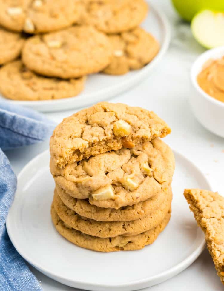 Apple and Peanut Butter Cookies stacked on plate with one cookie broken in half