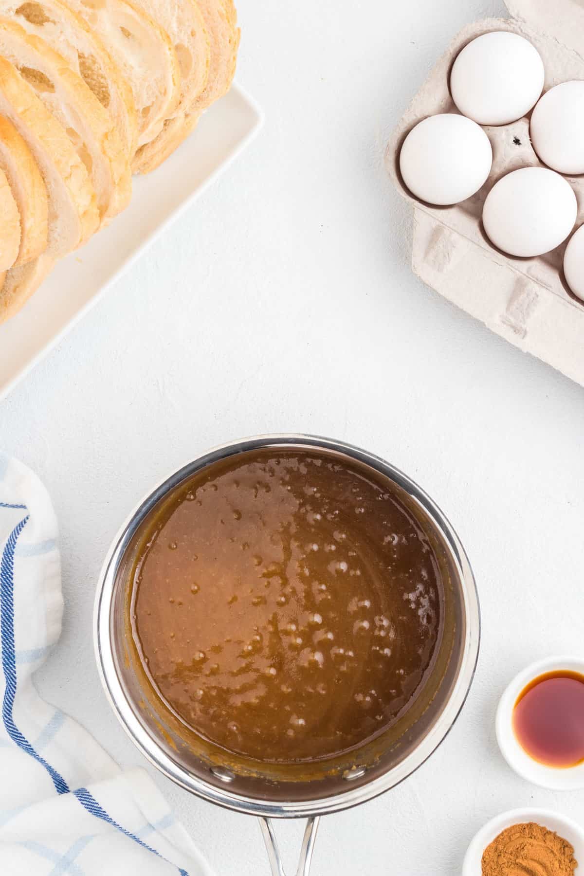 Bubbling butter and brown sugar mixture in saucepan for Overnight French Toast Bake