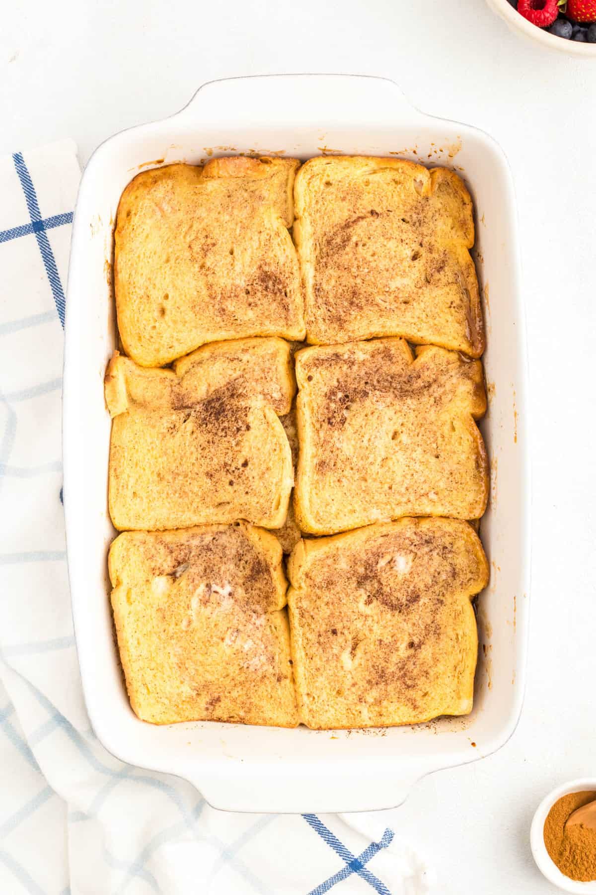 Baked french toast to a golden brown in baking dish for Overnight French Toast