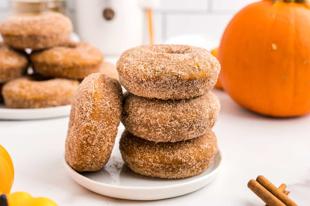 Baked Pumpkin Donuts stacked on plate 