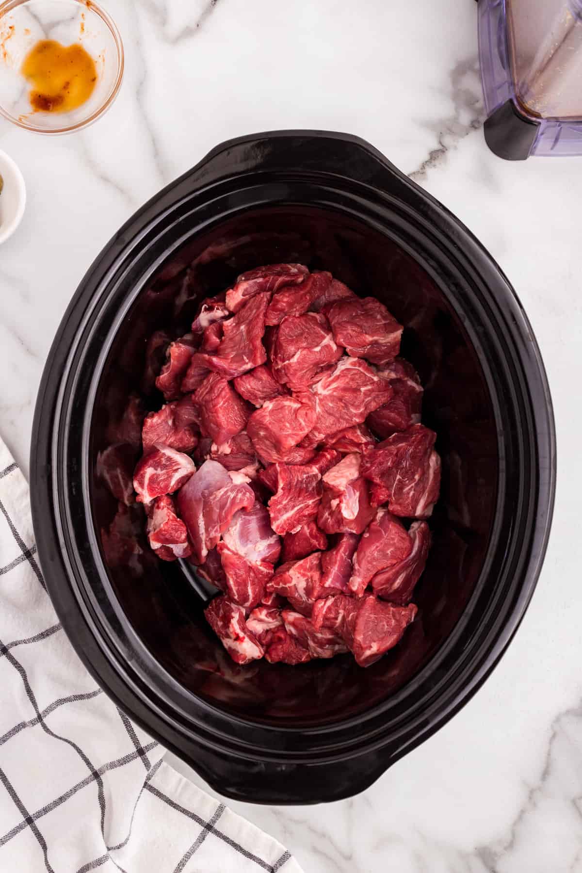 Chuck roast chunks in crock pot with Barbacoa Beef pureed seasoning