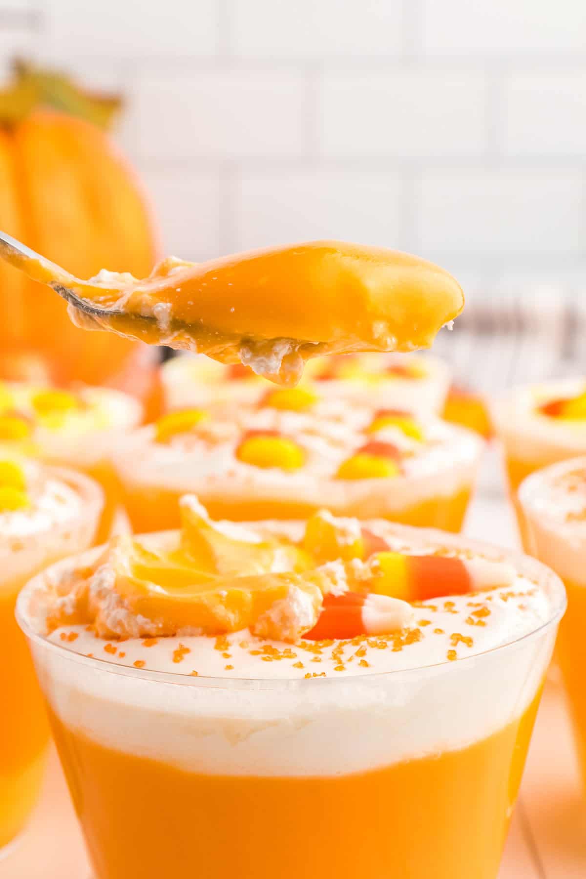 a Scoop taken out of the candy corn pudding cup.