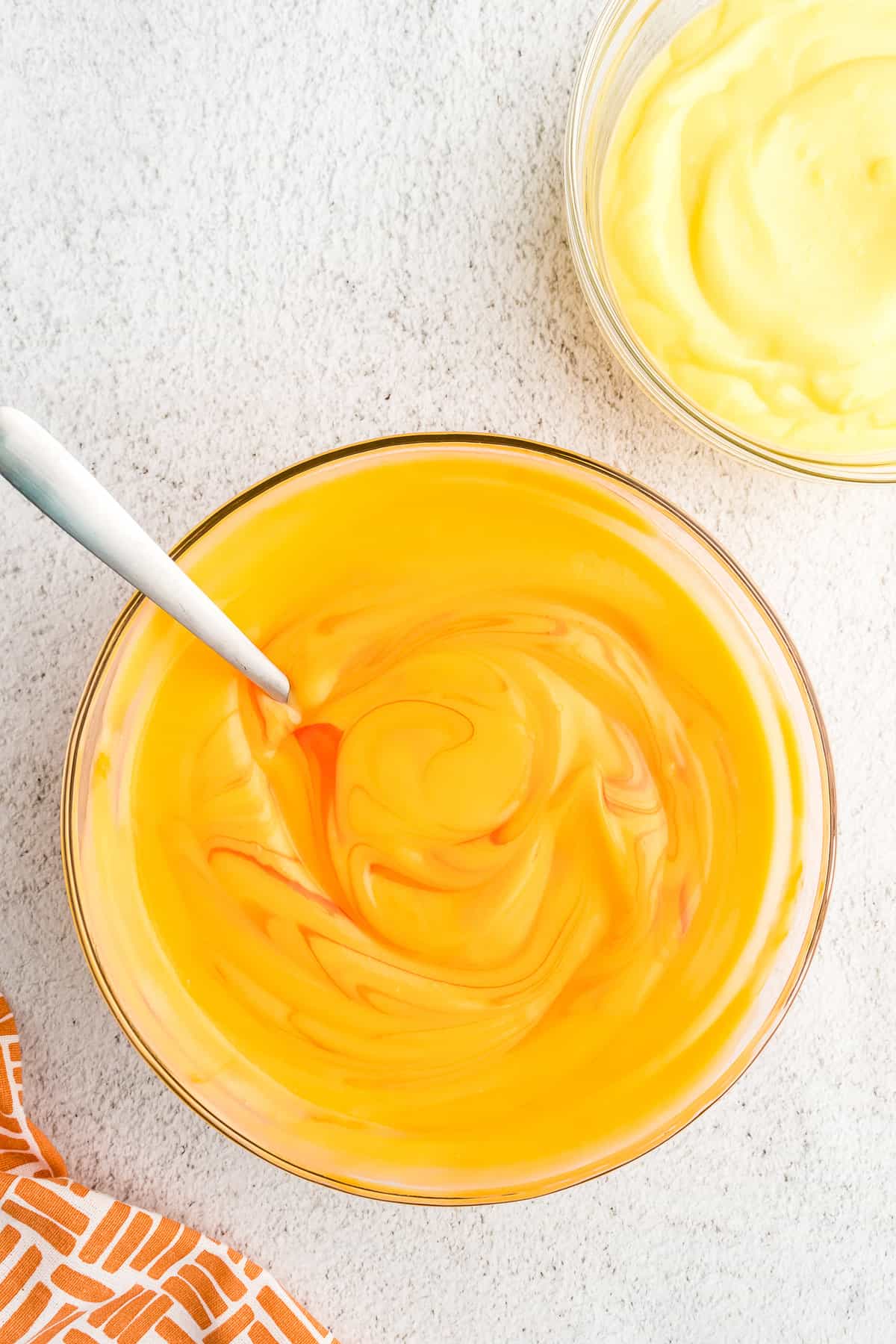 In the bowl with 4 cups of pudding add 5 drops of orange food coloring and mix together.