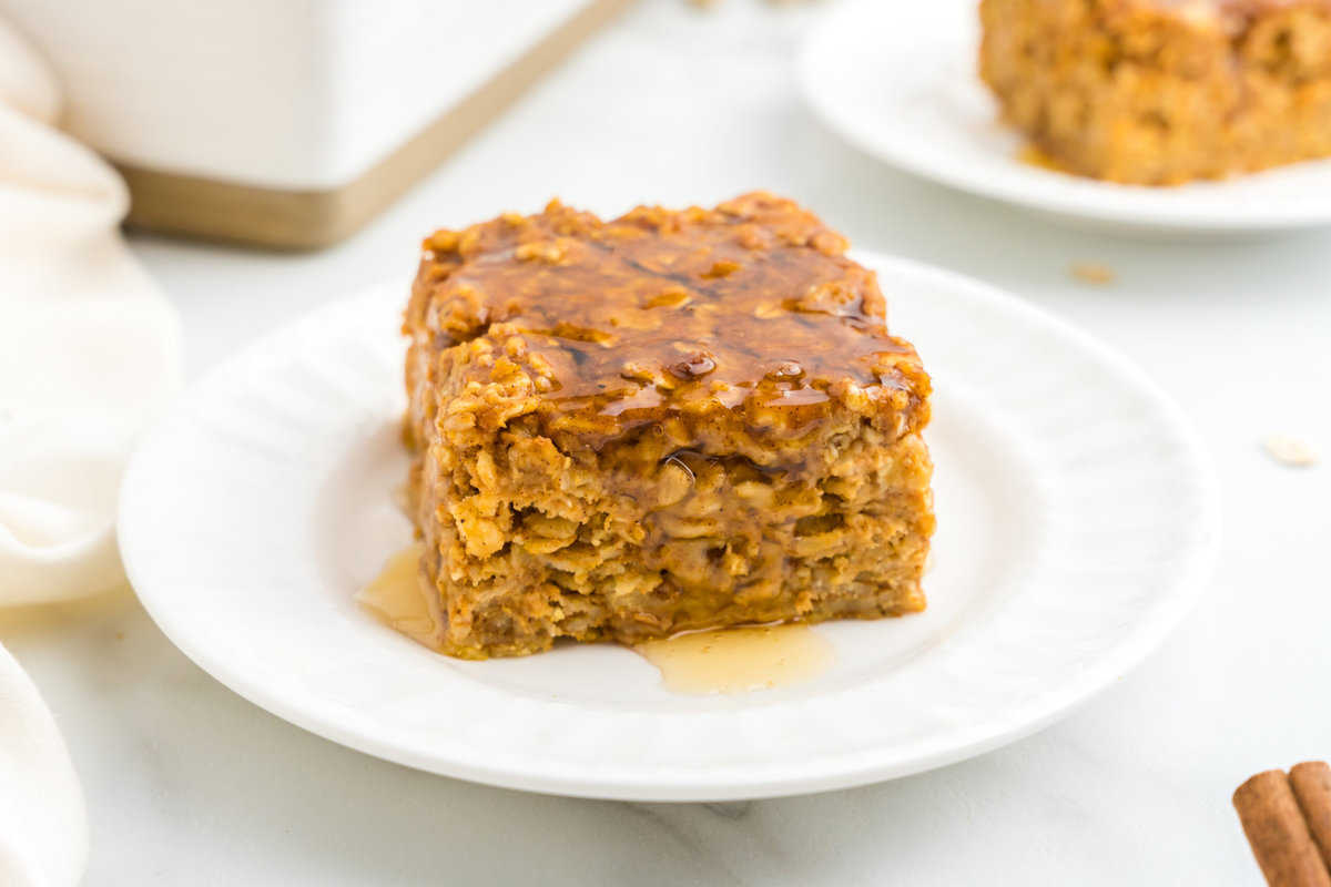Pumpkin Baked Oatmeal square on plate drizzled with honey