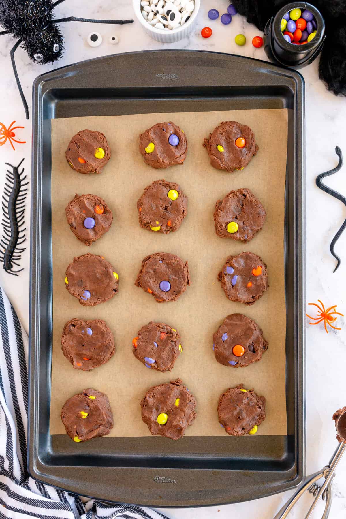 Place parchment paper on baking sheet and place 1 1/2 inch cookie balls throughout the cookie sheet pressing them down to flatten them evenly with your fingers.