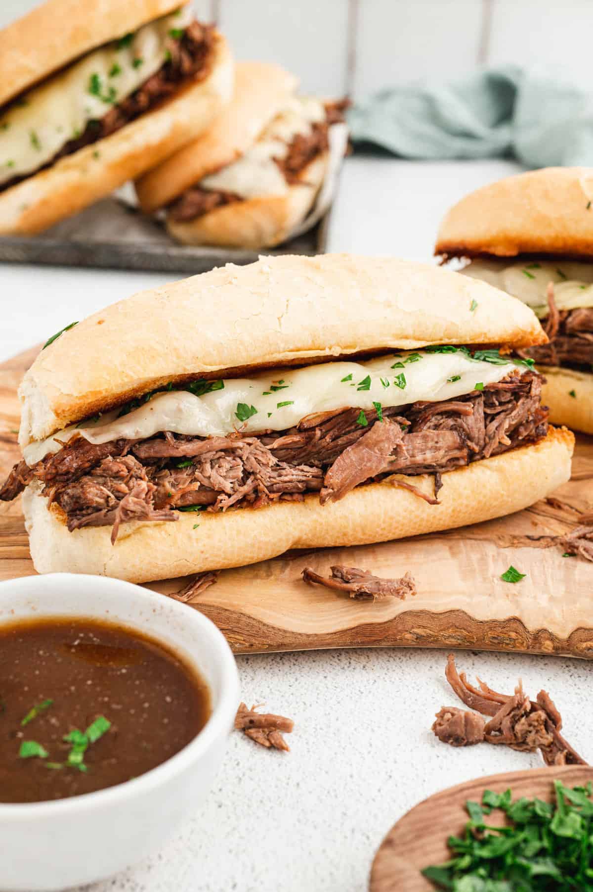 French Dip Sandwich on cutting board with salty au jus.