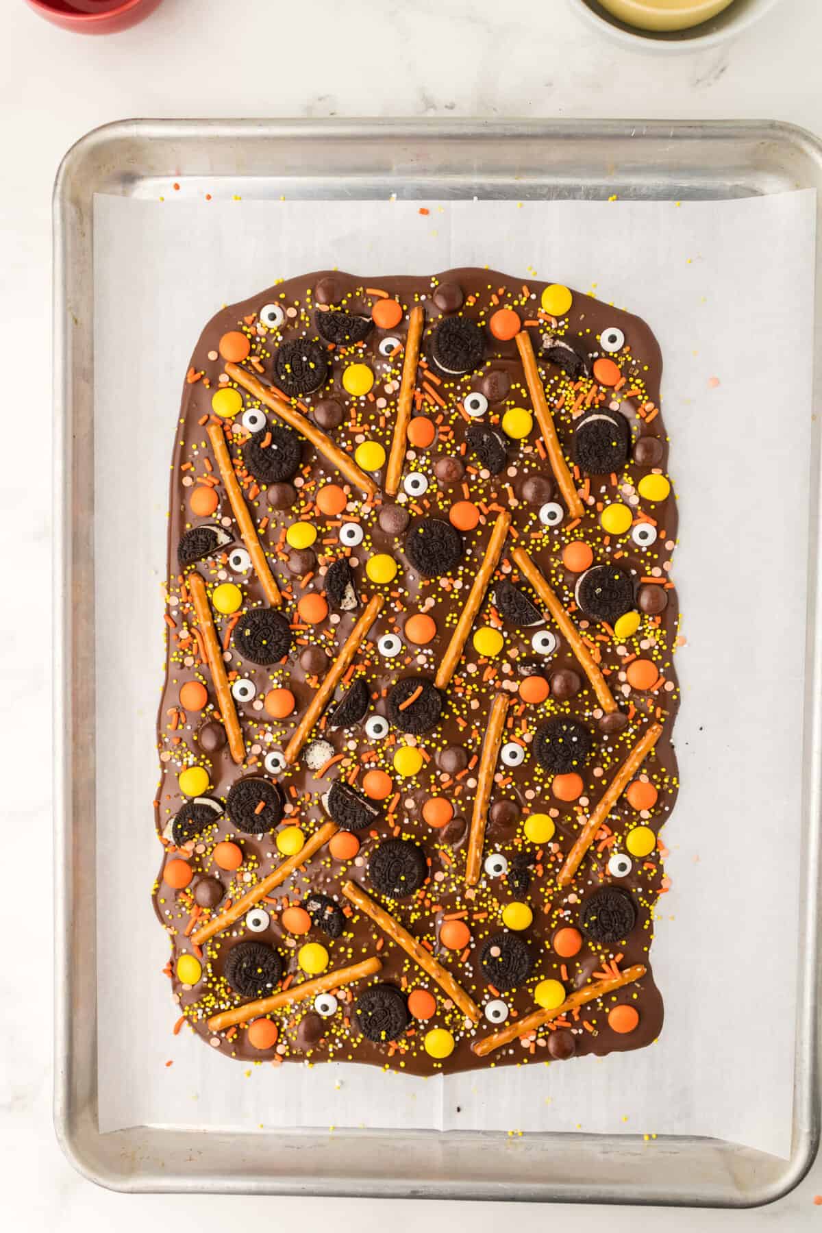 Sprinkle on the Halloween Sprinkles and Eye Candies all over the remaining chocolate. Put into the refrigerator to harden