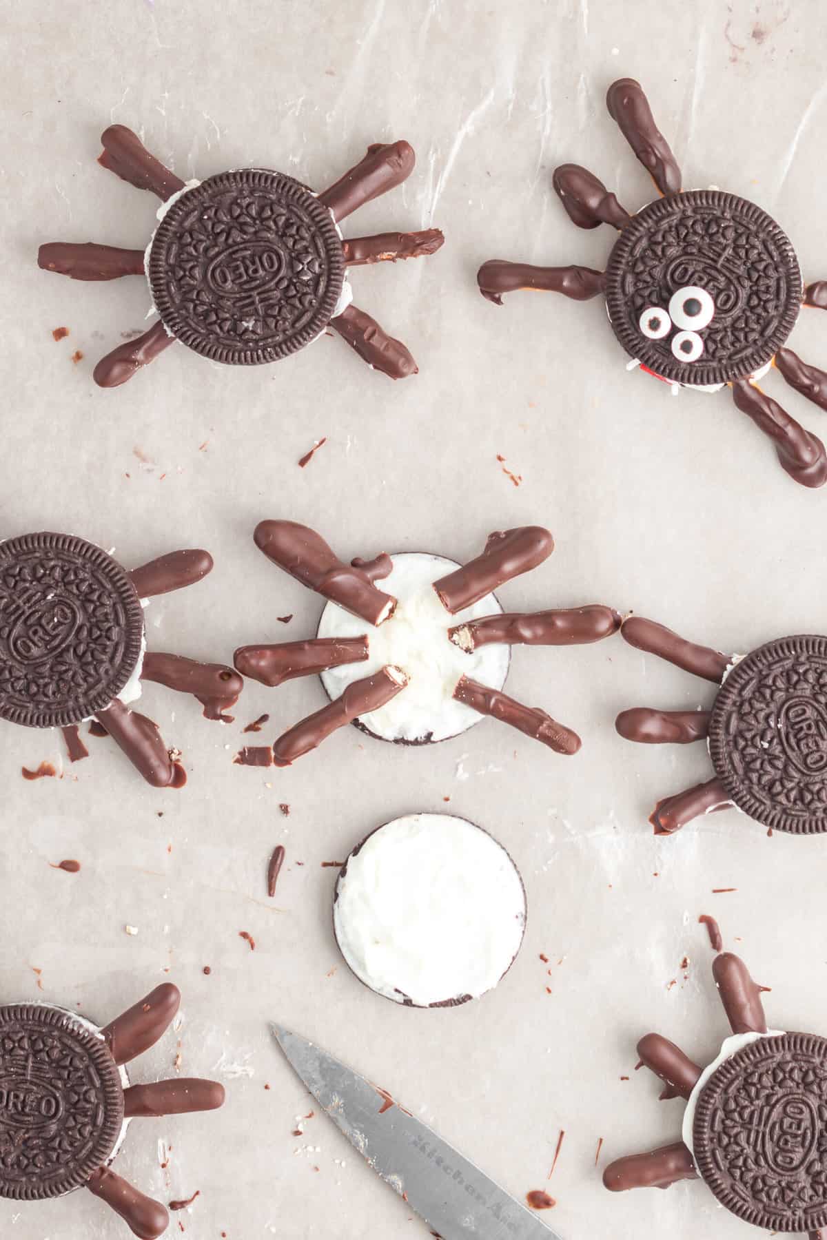 Carefully separate the oreo in half. Press the 6 leg pieces into the oreo cream.