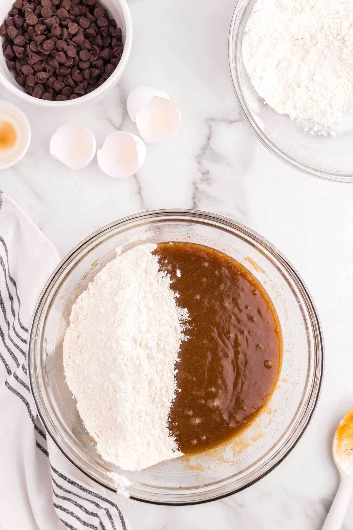 Folding in flour to Soft Pumpkin Chocolate Chip Cookies recipe in mixing bowl