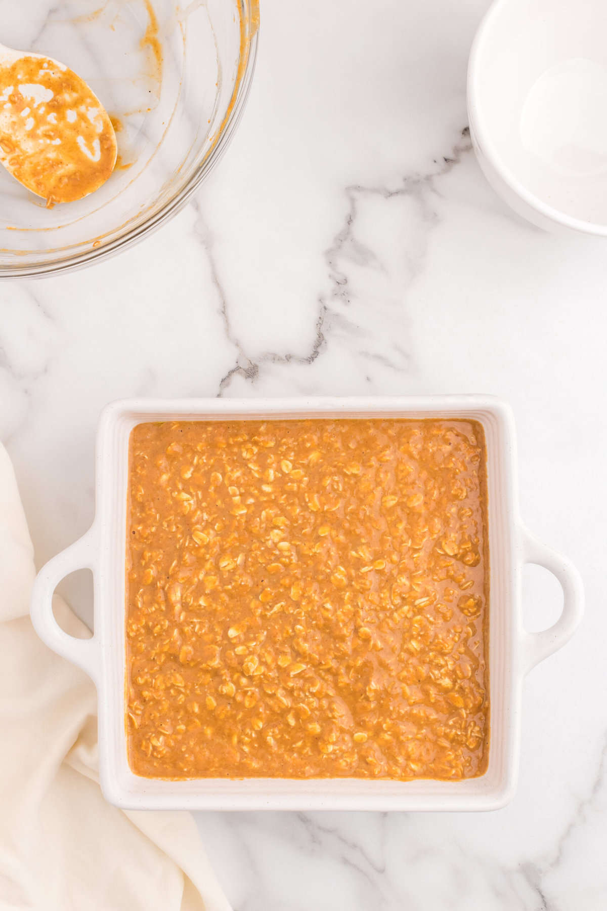 Baked Pumpkin Oatmeal recipe in square baking dish before baking