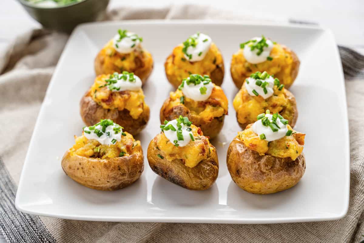 Mini Twice Baked Potatoes Loaded with Sour Cream and Chives on Plate 